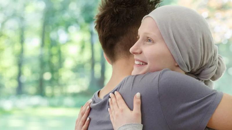Husband hugging wife after receiving some good news.