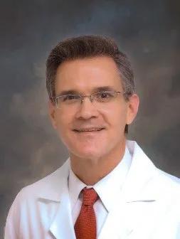 A person in a white coat and red tie AI-generated content may be incorrect.