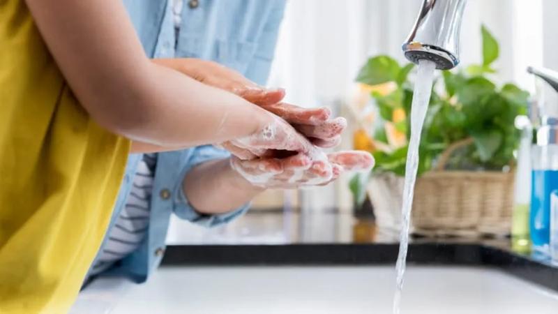 Parent and child washing their hands