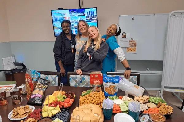 Amy Dittmar and medical staff with food on table