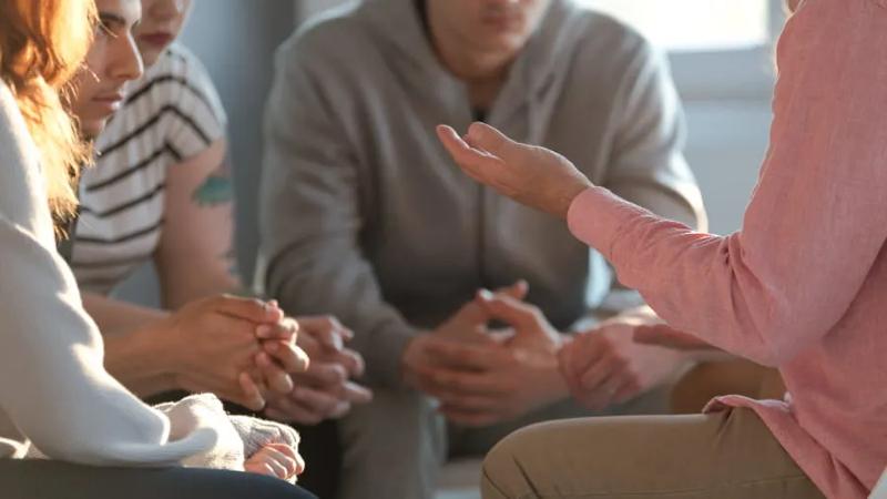 Group of people talking in group therapy