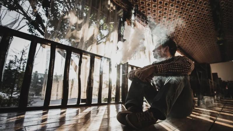 man sitting down smoking