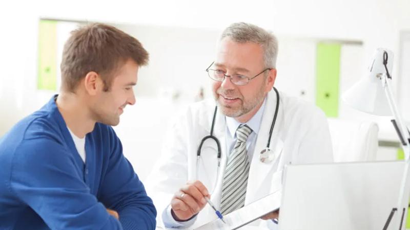 Male doctor talking to male patient