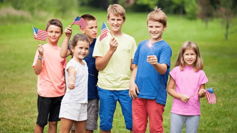 Kids hold American flags