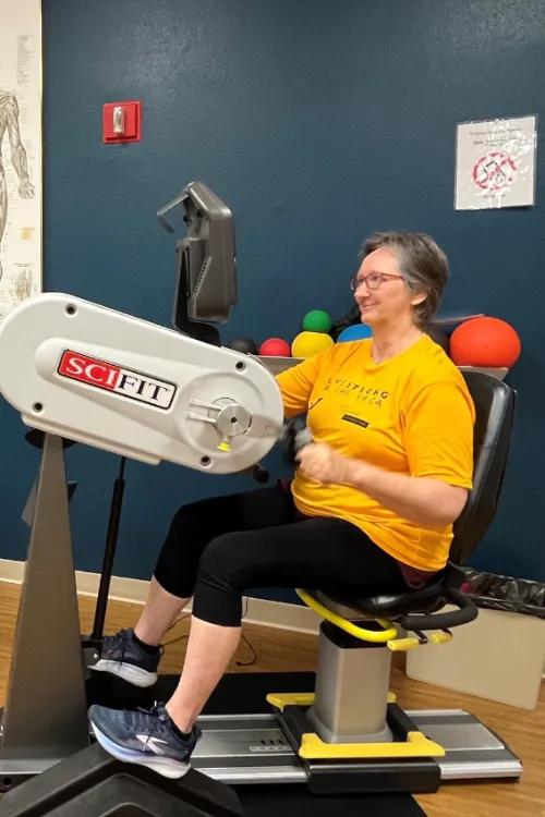 Lady working out with hand bicycle machine